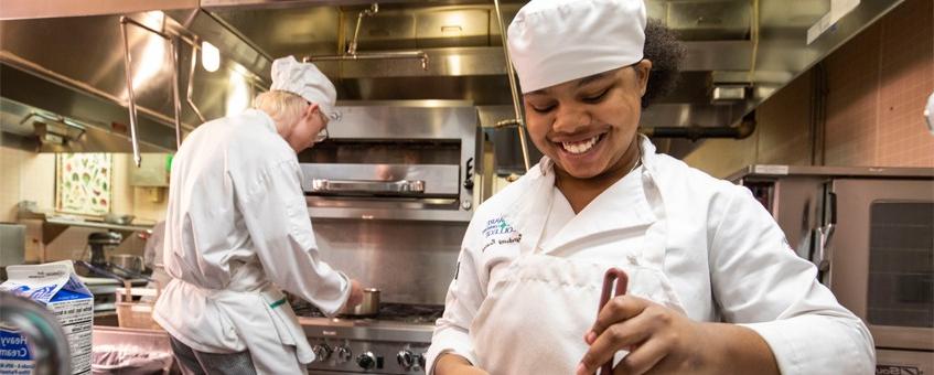 Two Culinary students working in the kitchen.